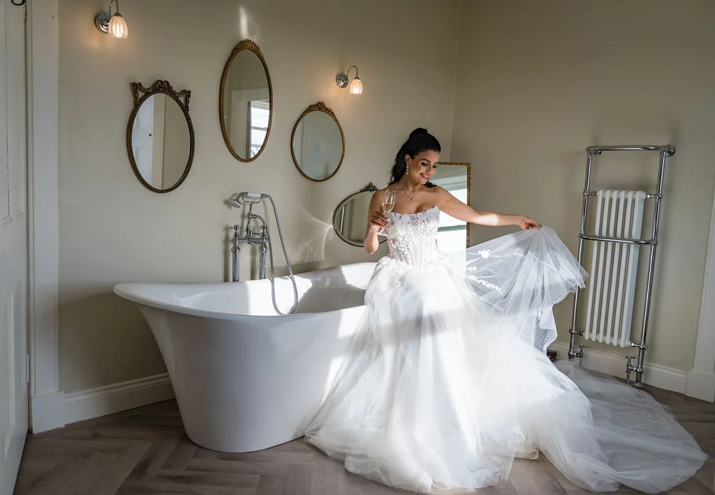 Bride in the luxurious bridal suite dressing room. Dress by The Hitching Post Bridal. Photography by ZibiZPhoto.