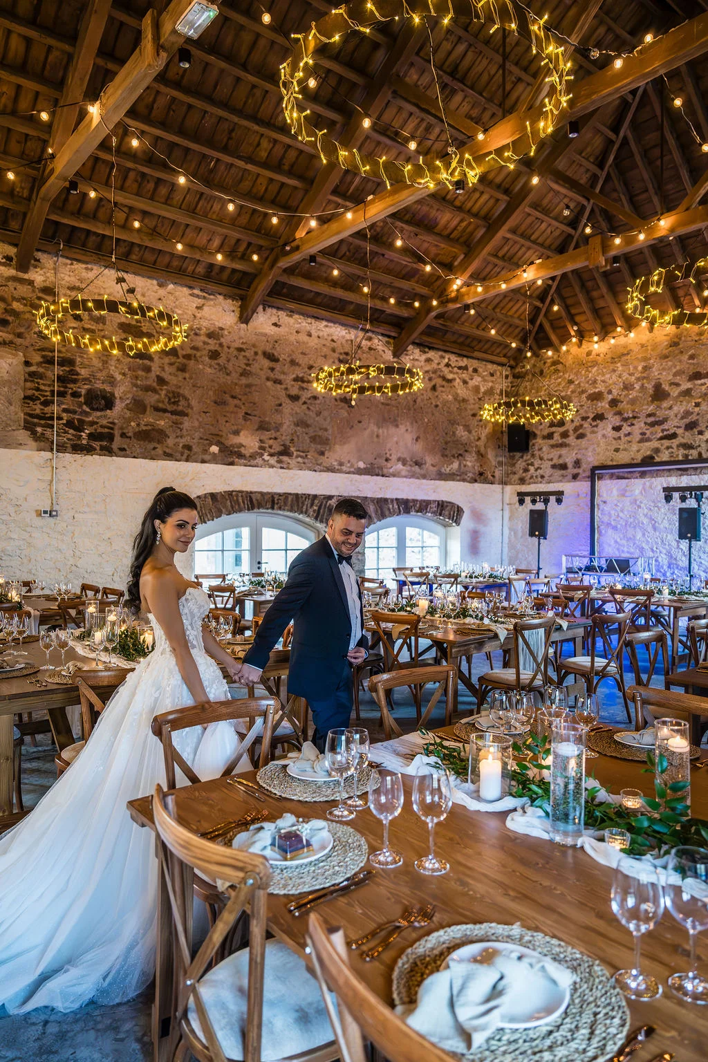 The atmospheric Granary at Kinclune Steading styled for the wedding breakfast. Dress by The Hitching Post Bridal. Photography by ZibiZPhoto.