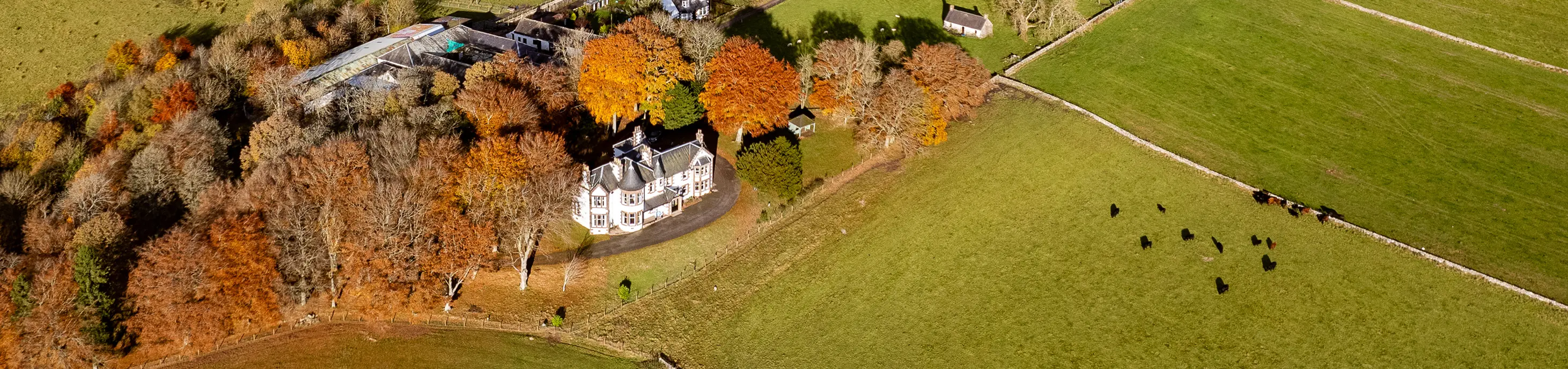 Kinclune House and steading in autumn aerial view