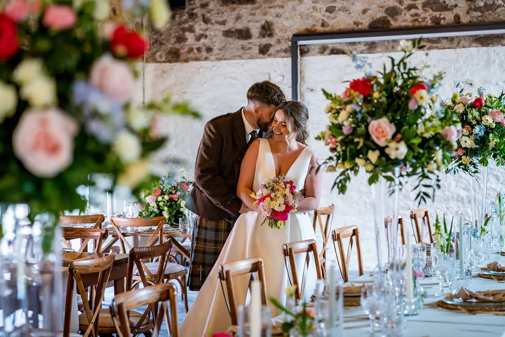 The grand barn at Kinclune Steading, with bride and groom and stunning wedding decor -ZibiZPhoto