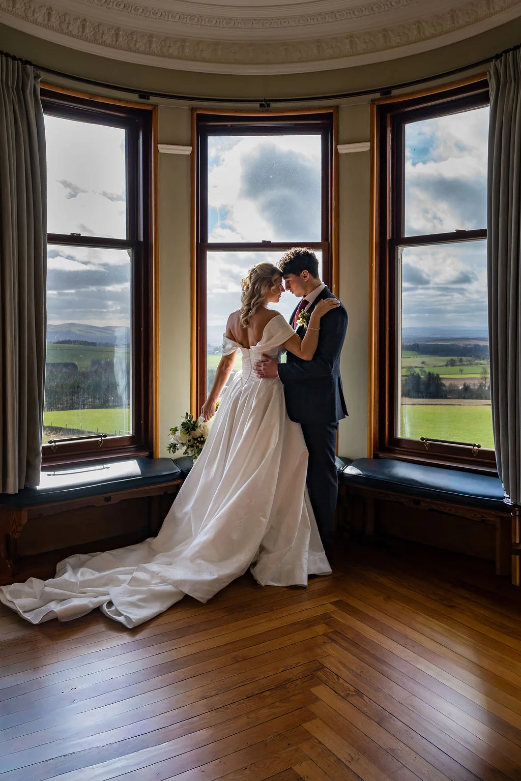 Wedding couple in the Kinclune House grand drawing room tower feature bay window. Dress by The Hitching Post Bridal. Photography by ZibiZPhoto.