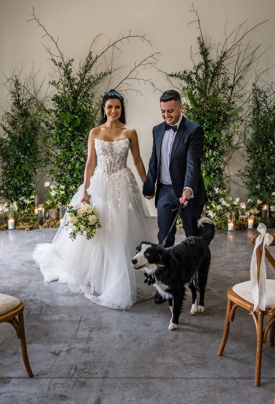 Wedding couple with their dog in The Arches ceremony space - a welcome addition to the wedding celebration. Dress by The Hitching Post Bridal. Photography by ZibiZPhoto.