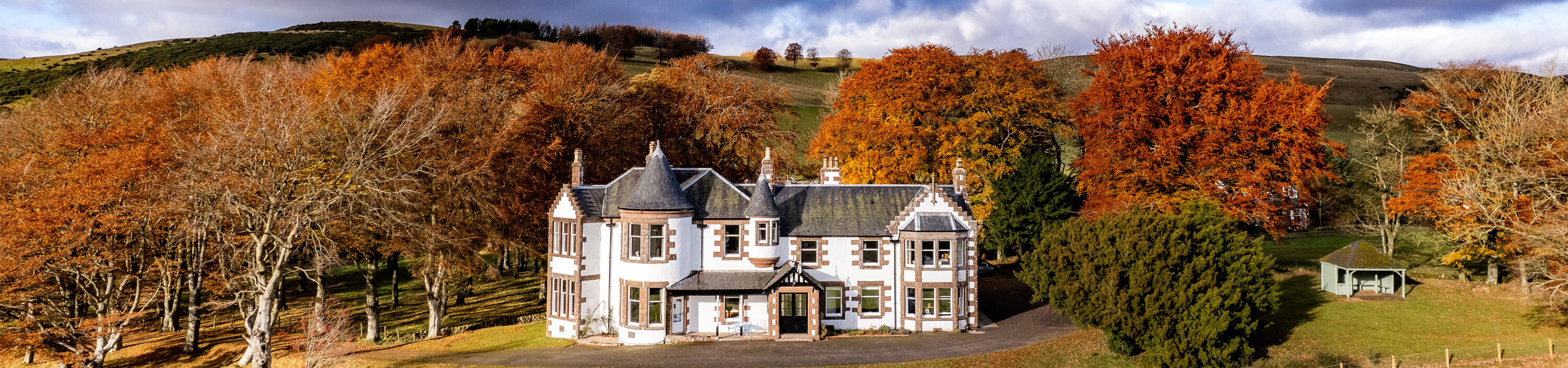 Kinclune House set in autumnal woodland